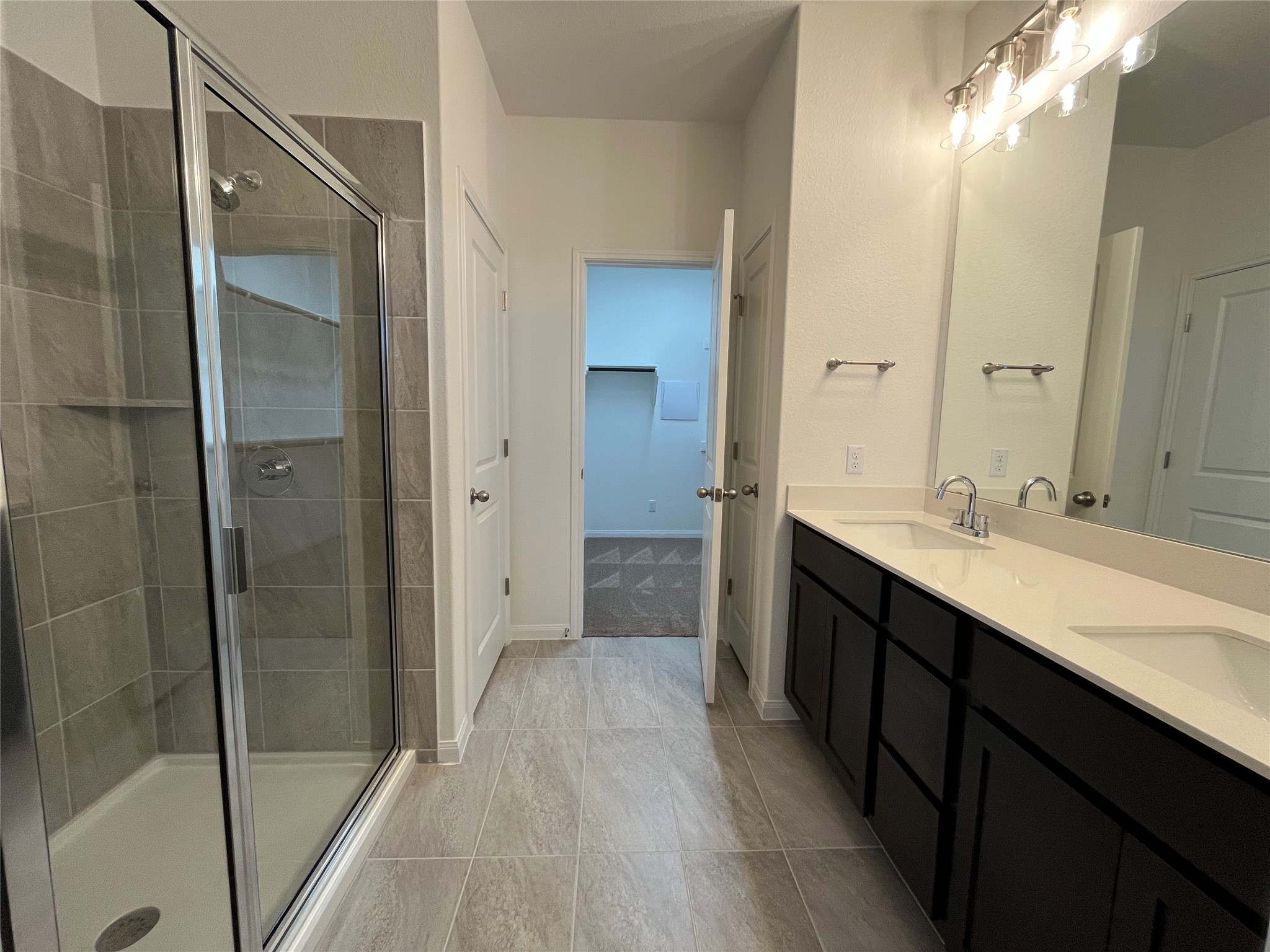 8522 Wellspring Loop Round Rock, TX 78665 - Photo 15 of 36 Masterbath with large walk-in shower, double vanity and walkin closet. For demonstration purposes only. This will be the same interior layout. Colors can vary.