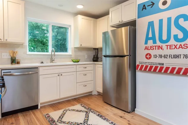 a kitchen with a refrigerator and a sink