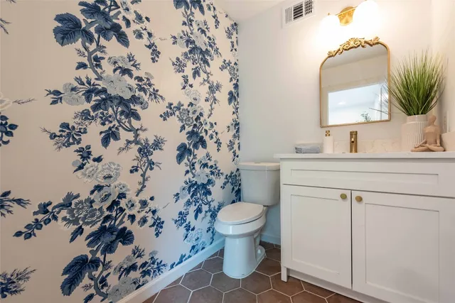 a bathroom with a sink toilet and mirror