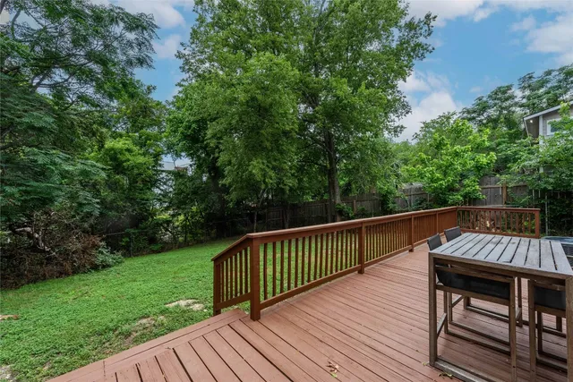 a view of backyard with deck and outdoor seating