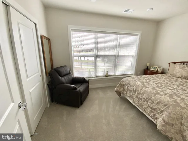 a spacious bedroom with a bed and a couch