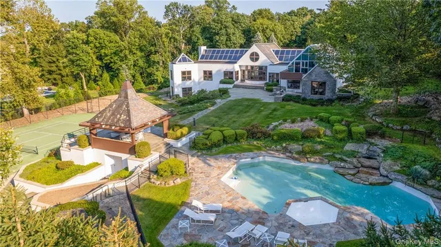 an aerial view of a house with a yard basket ball court and outdoor seating