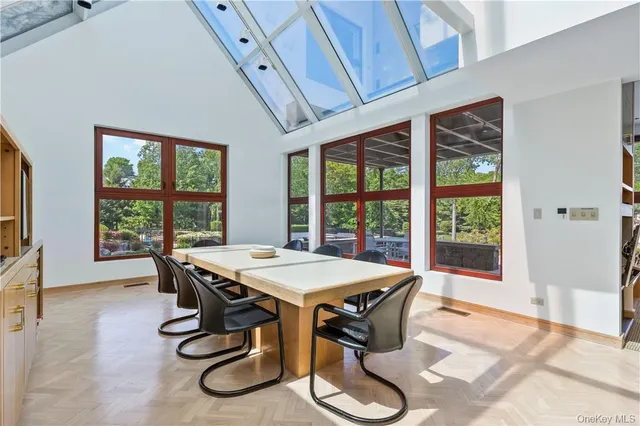 a bedroom with a bed chair and a large window
