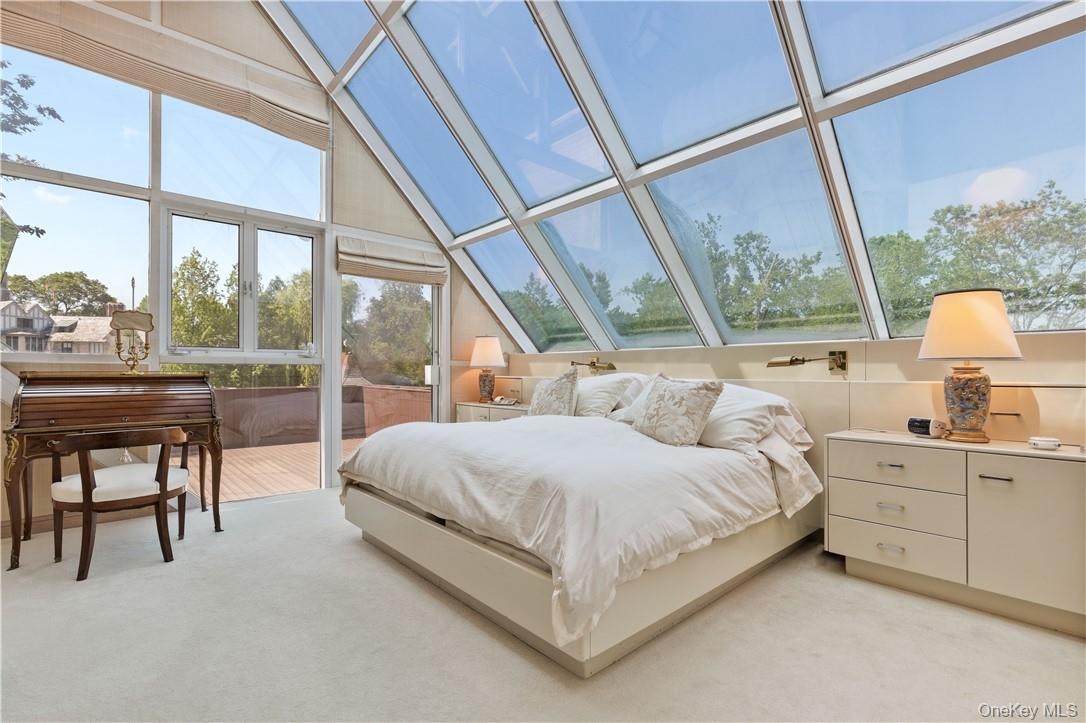 40 Polly Park Road Rye, NY 10580 - Photo 18 of 36 a bedroom with a bed chair and a large window