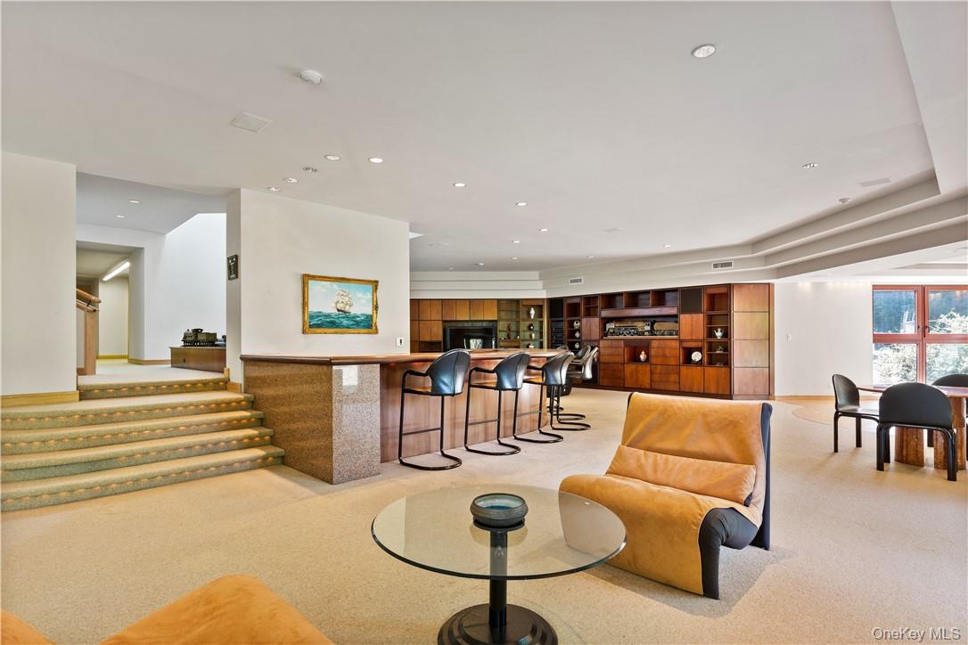40 Polly Park Road Rye, NY 10580 - Photo 27 of 36 a living room with furniture a dining table and kitchen view