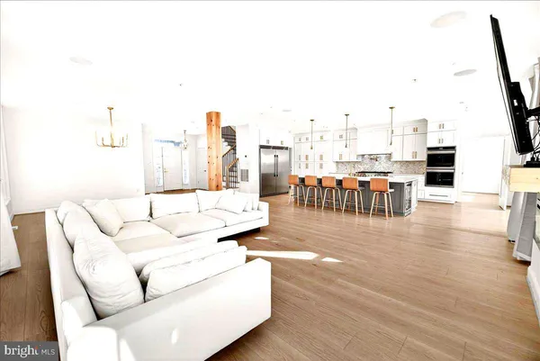 a bedroom with a large bed and a potted plant on the dresser