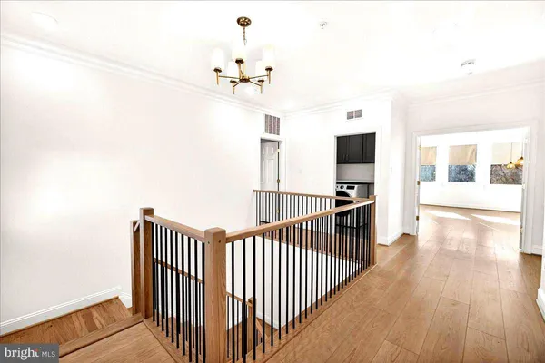 a view of a room with wooden floor and a window