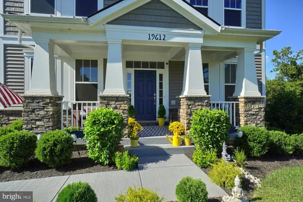 a front view of a house with plants