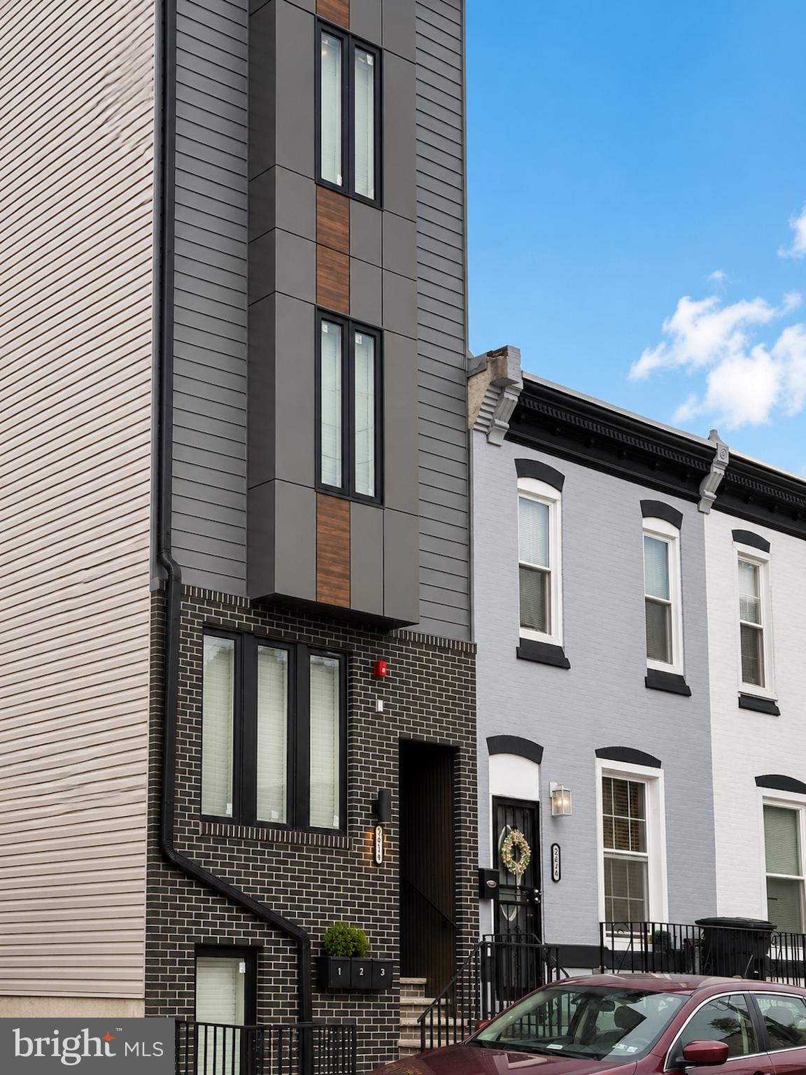 2614 North 7th Street, Unit 2 Philadelphia, PA 19133 - Photo 1 of 10 a front view of a residential apartment building with a yard