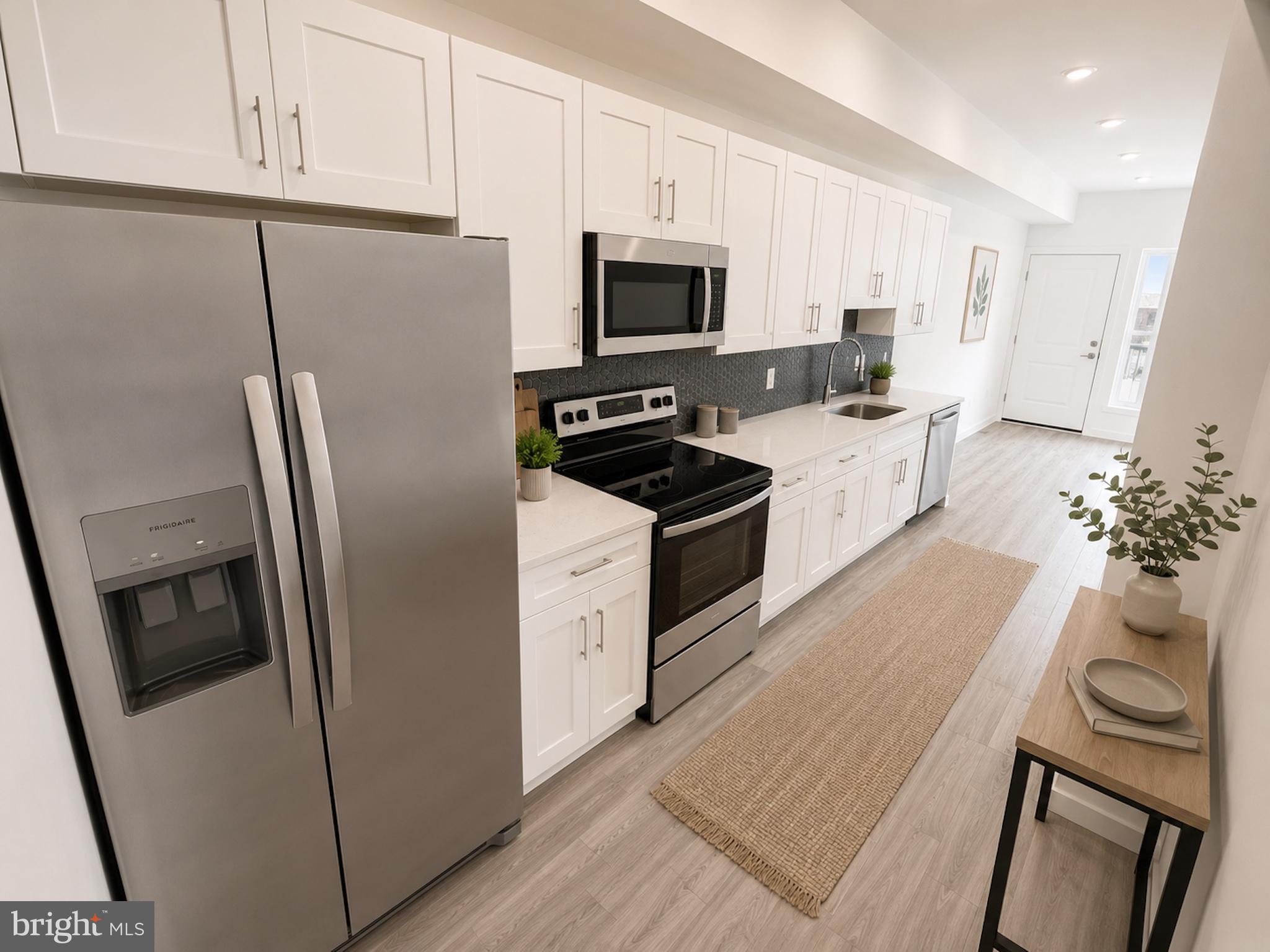 2614 North 7th Street, Unit 2 Philadelphia, PA 19133 - Photo 2 of 10 a kitchen with stainless steel appliances a refrigerator a stove a microwave and cabinets