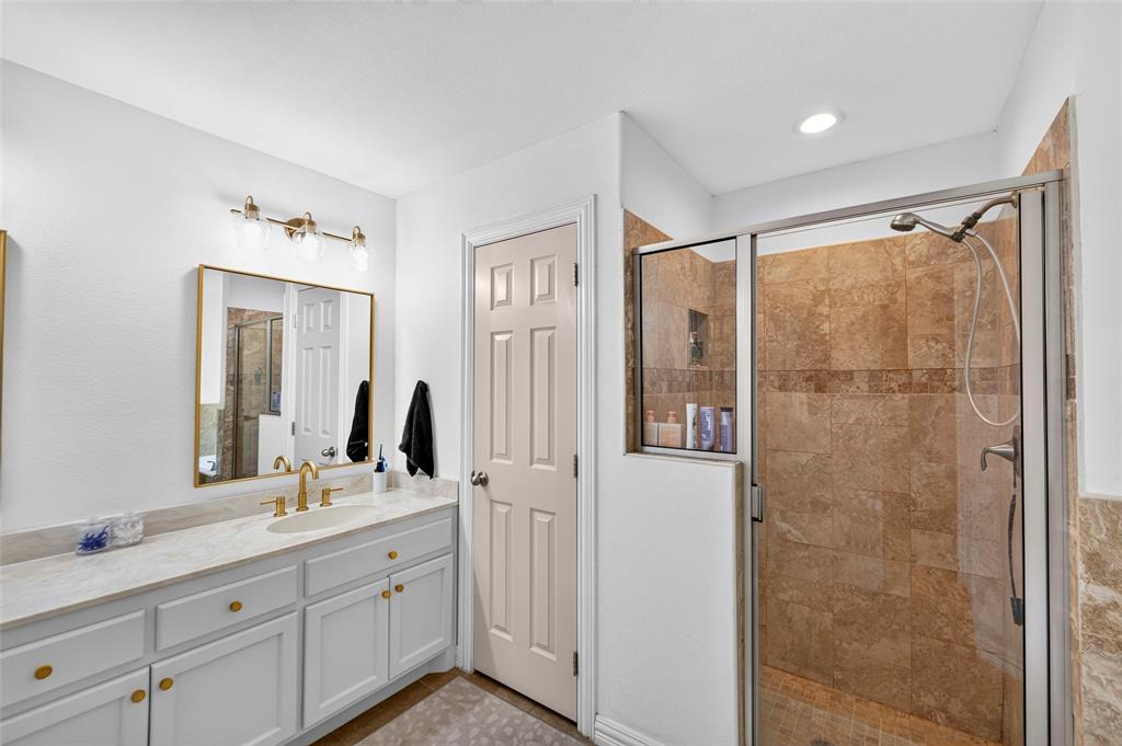 8014 Garner Road Rowlett, TX 75088 - Photo 23 of 39 a bathroom with a double vanity sink and mirror