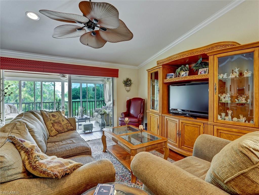 895 Eastham Way, Unit M202 Naples, FL 34104 - Photo 15 of 37 a living room with furniture and a flat screen tv