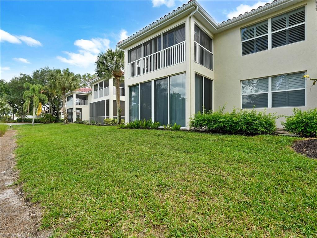 895 Eastham Way, Unit M202 Naples, FL 34104 - Photo 35 of 37 a front view of a house with a yard