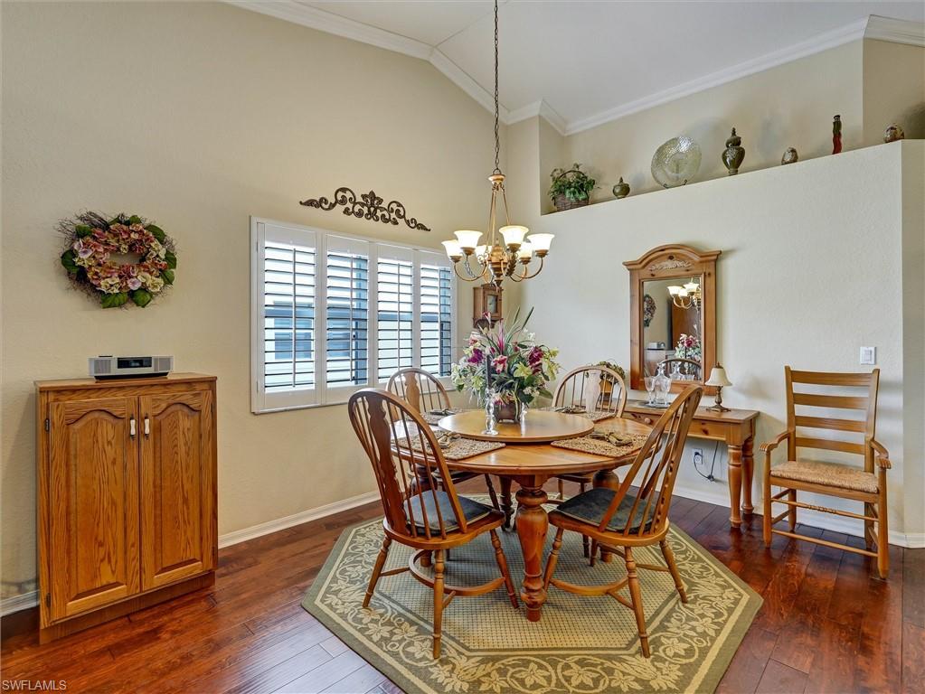 895 Eastham Way, Unit M202 Naples, FL 34104 - Photo 36 of 37 a view of a dining room with furniture and wooden floor