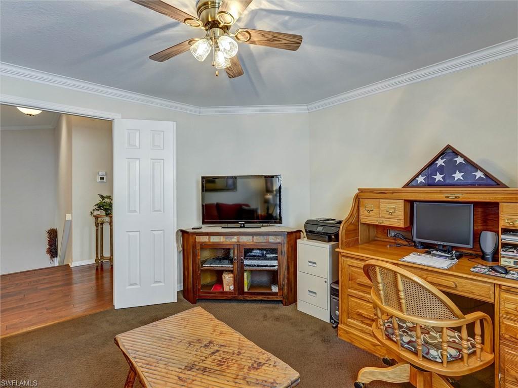 895 Eastham Way, Unit M202 Naples, FL 34104 - Photo 37 of 37 a view of a livingroom with furniture and a flat screen tv
