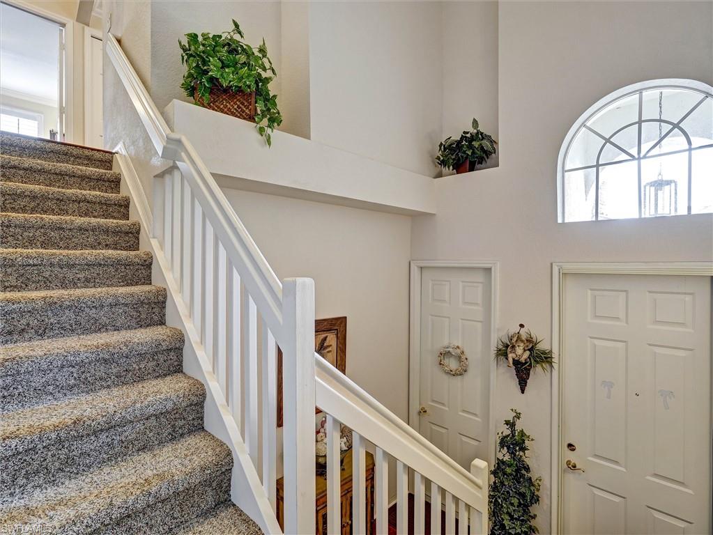 895 Eastham Way, Unit M202 Naples, FL 34104 - Photo 4 of 37 a view of entryway and hall with wooden floor