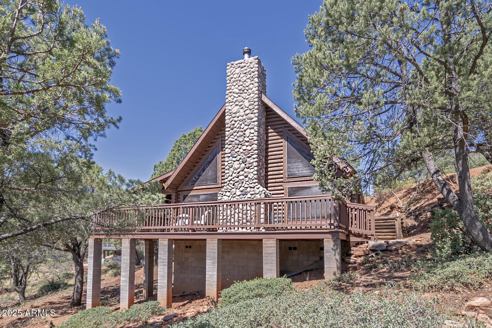 5945 Arroyo Way Pine, AZ 85544 - Photo 12 of 38 a view of a house with a yard and balcony