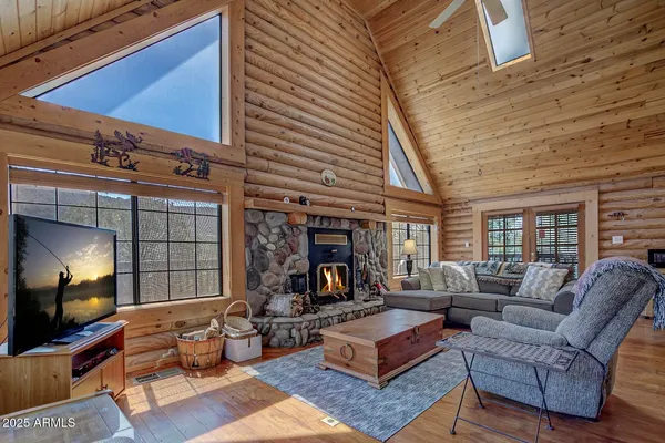 a living room with furniture fireplace and a large window