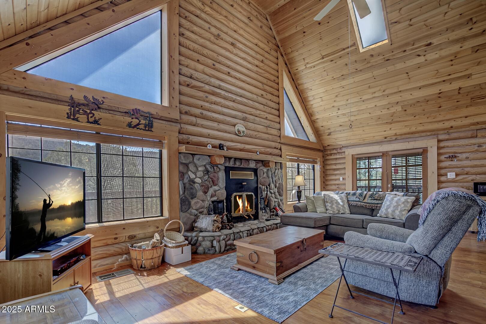 5945 Arroyo Way Pine, AZ 85544 - Photo 15 of 38 a living room with furniture and a fireplace