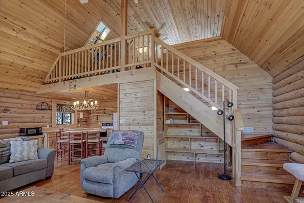 a view of a dining room with furniture wooden floor and chandelier