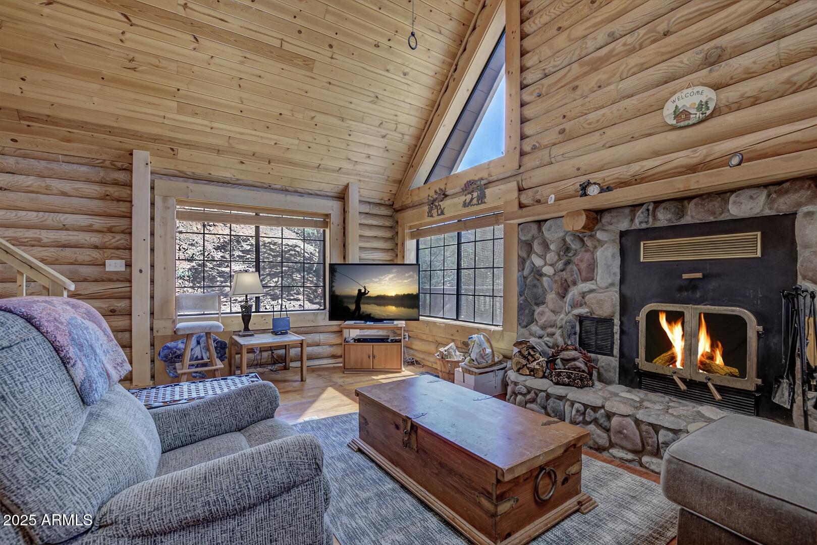 5945 Arroyo Way Pine, AZ 85544 - Photo 17 of 38 a living room with furniture fireplace and a large window