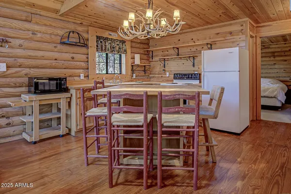 a bedroom with a bed next to a window with a flat tv screen