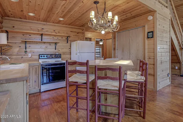 a bedroom with a bed wooden floor and window