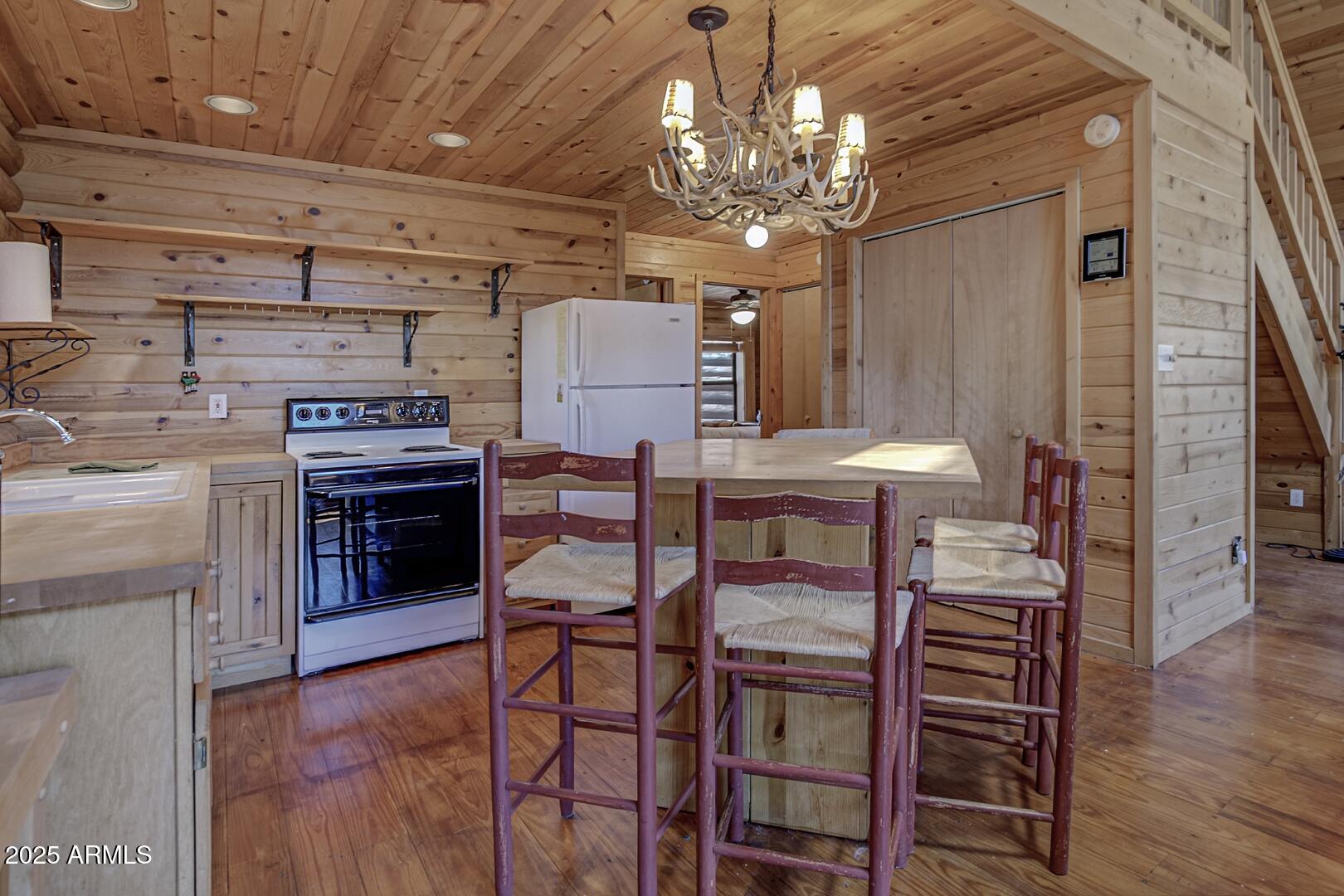 5945 Arroyo Way Pine, AZ 85544 - Photo 19 of 38 a view of a dining room with furniture and wooden floor