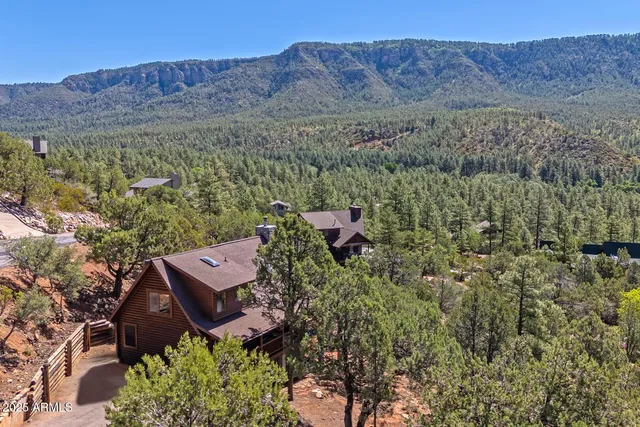 an aerial view of a house with mountain view