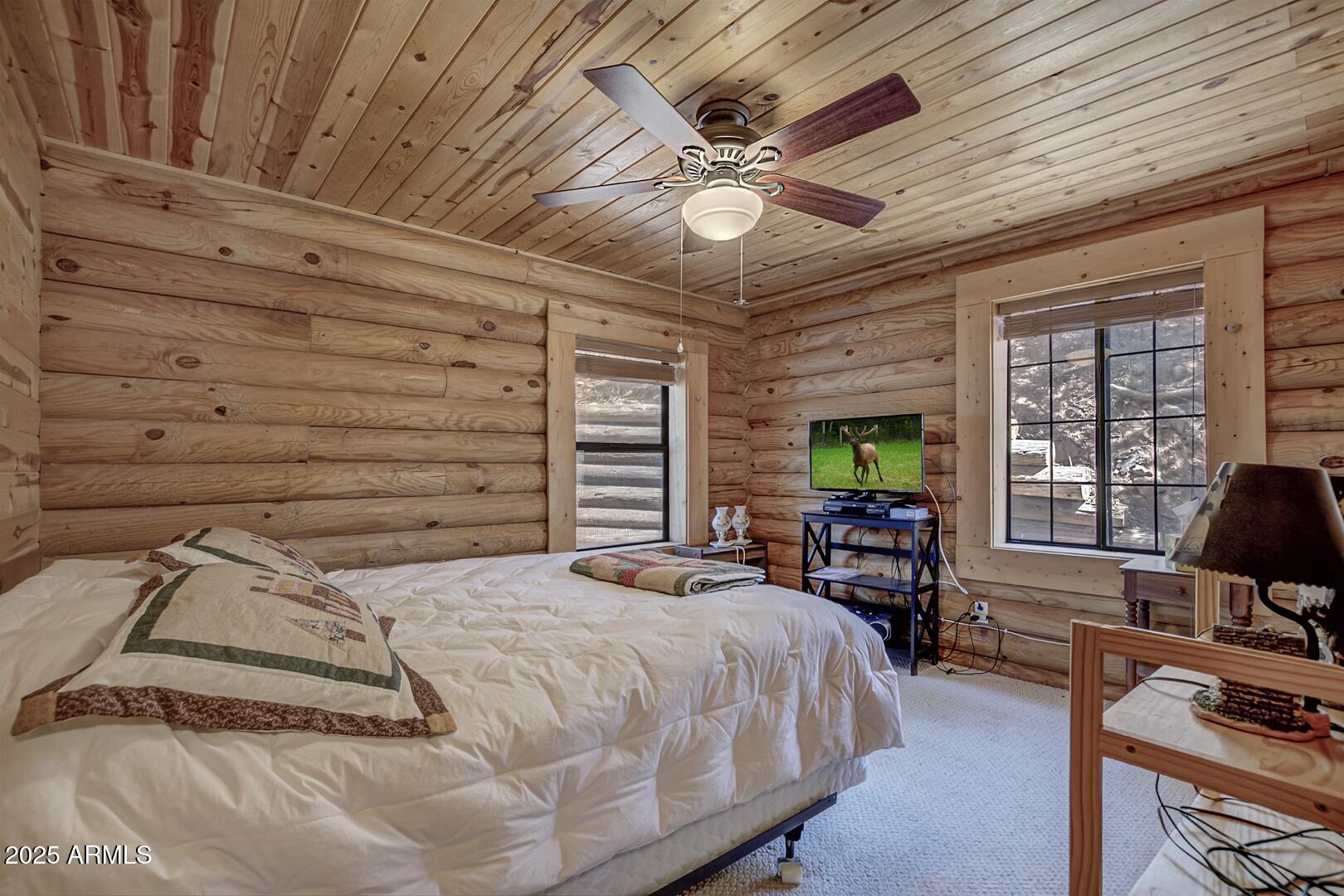 5945 Arroyo Way Pine, AZ 85544 - Photo 21 of 38 a bedroom with a bed wooden floor and window