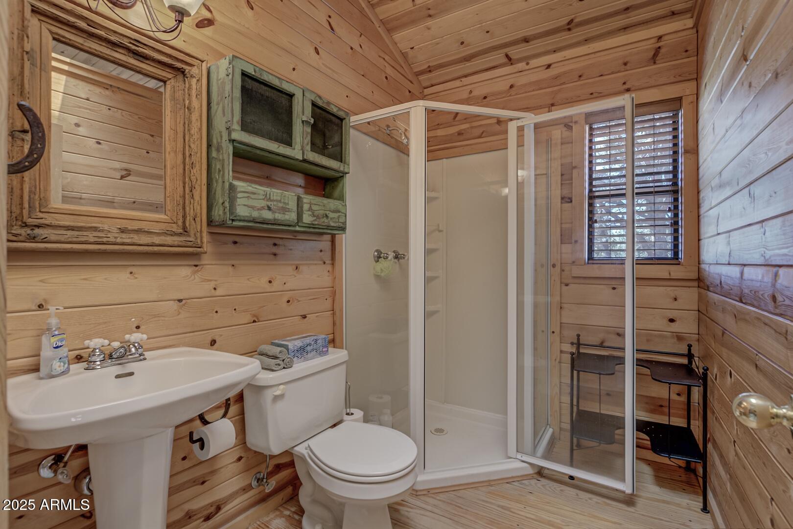 5945 Arroyo Way Pine, AZ 85544 - Photo 27 of 38 a bathroom with a sink a toilet and shower