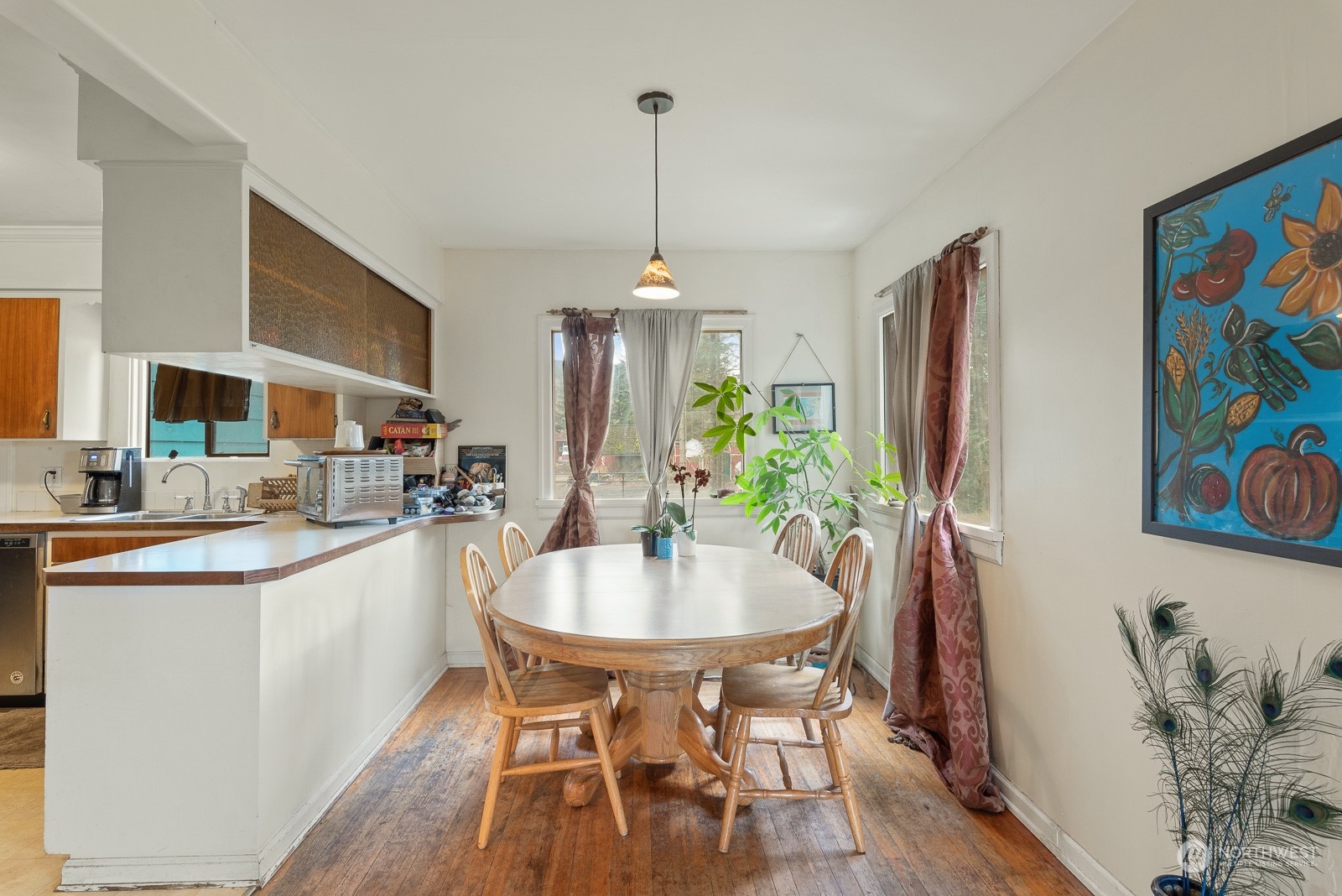 5709 Putnam Road Everson, WA 98247 - Photo 12 of 40 a kitchen with stainless steel appliances a dining table chairs and chandelier