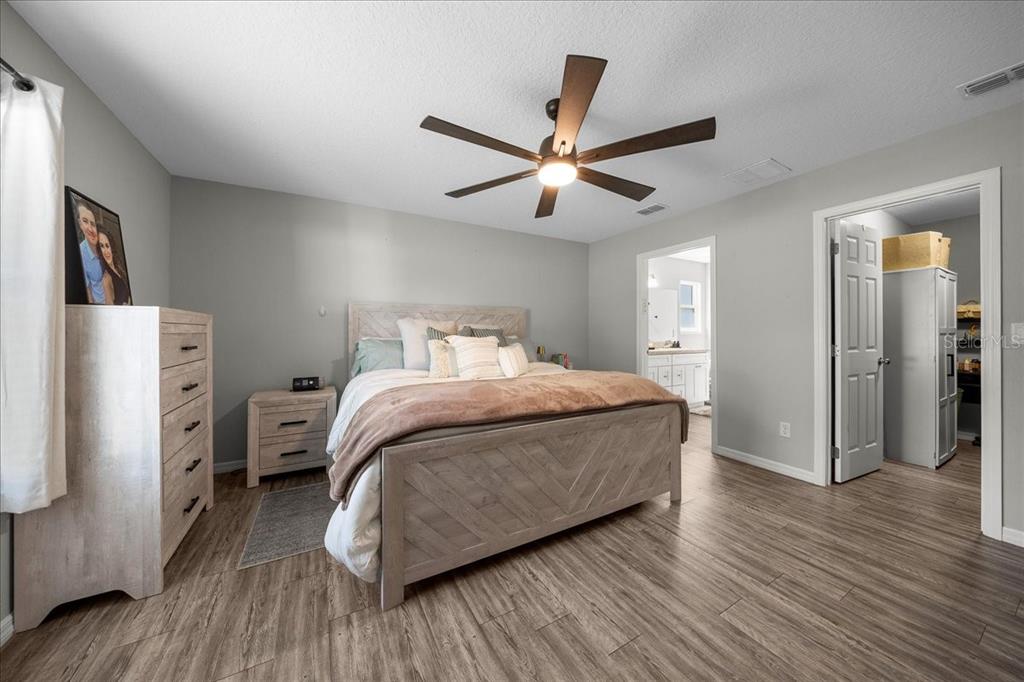 13 Teak Loop Place Ocala, FL 34472 - Photo 28 of 36 a bedroom with a bed and wooden floor