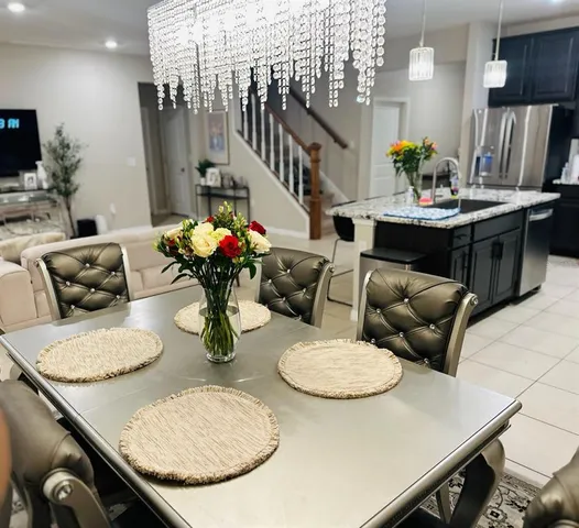 a kitchen with stainless steel appliances kitchen island granite countertop a table and chairs