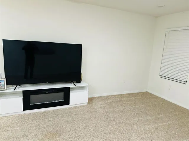 a view of empty room with a fireplace