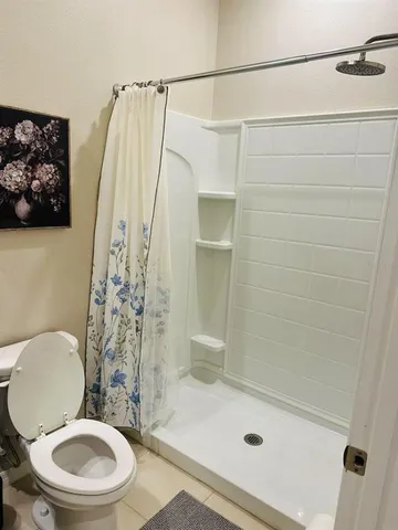 a bathroom with a toilet and shower