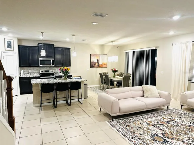 a living room with furniture and kitchen view