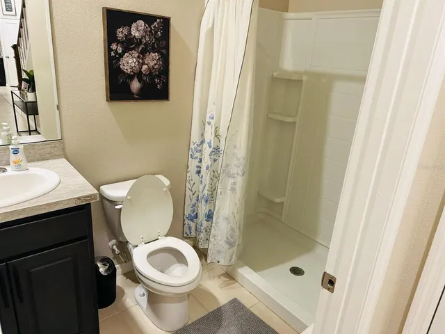 a white toilet sitting next to a bathroom sink