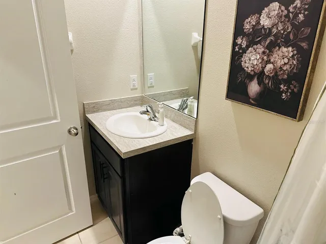 a bathroom with a sink toilet and mirror