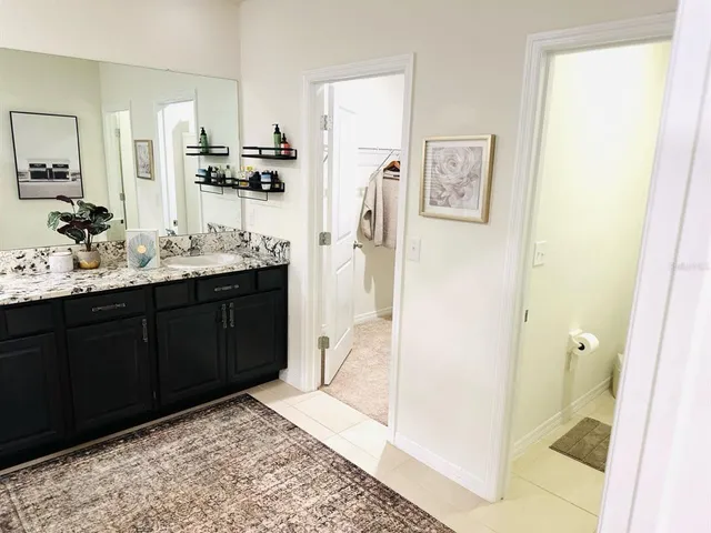 a bathroom with a double vanity sink and mirror