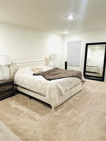 a bedroom with a bed and a mirror