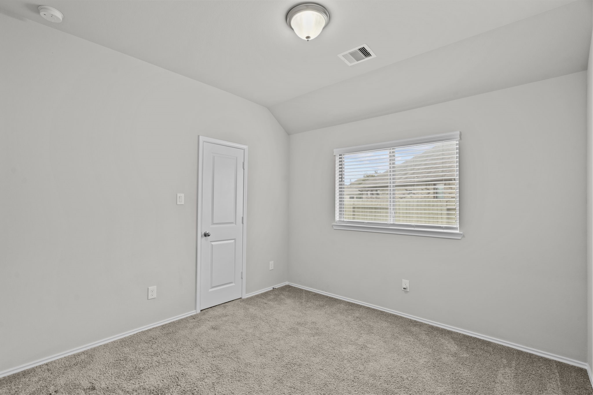 2011 Oak Leaf Court Manvel, TX 77578 - Photo 21 of 28 This room is bright and simple, featuring light-colored walls, a carpeted floor, a central ceiling light, and a window that provides natural light. Perfect for a bedroom or office space.