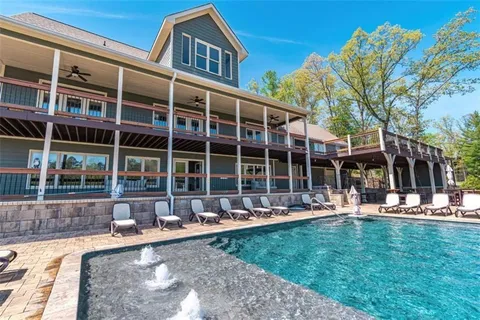 a front view of a building with a garden and sitting area
