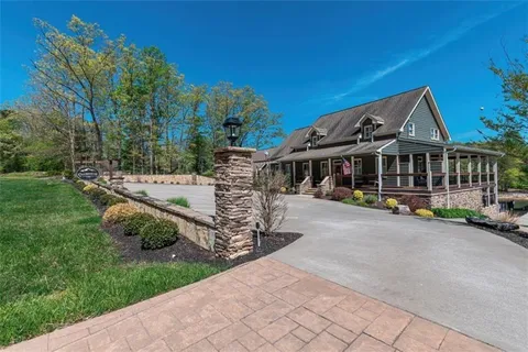a view of a house with backyard sitting area and garden