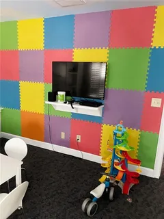 a room with furniture and a flat screen tv