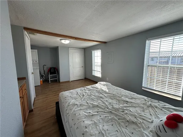 a bedroom with a bed and a large window