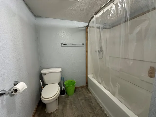a bathroom with a toilet and shower
