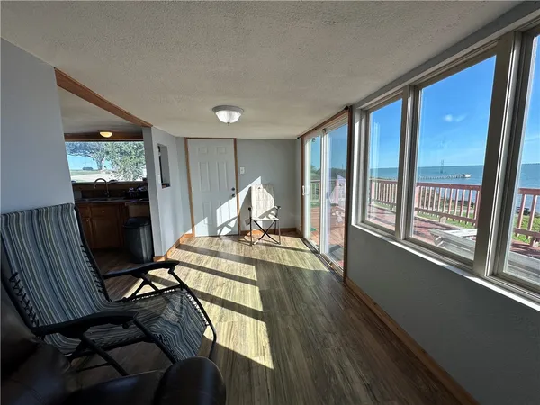 a view of a livingroom with furniture window and wooden floor