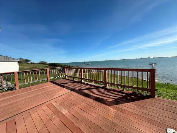 a view of a balcony with two chairs and a barbeque