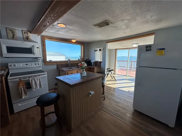 a kitchen with sink refrigerator and stove